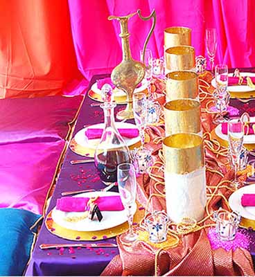 blue pink and purple decorative fabrics with golden candle and pink napkins for Arabian Nights theme party table decoration 