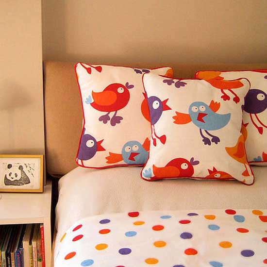red and blue kids bedding with birds images on pillows