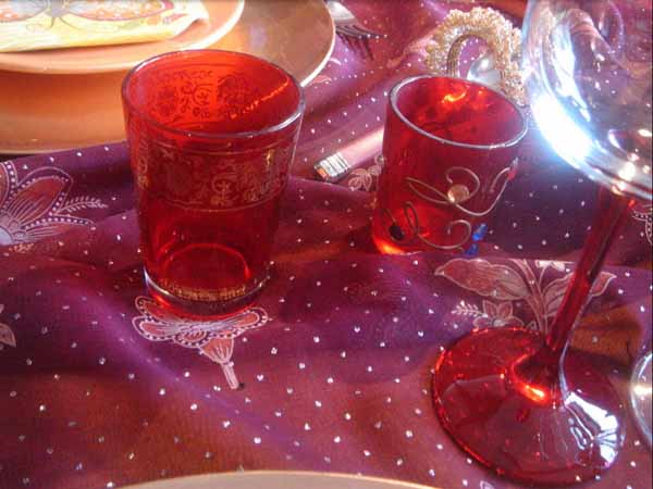 colorful glasses with tea light candles for table decorating