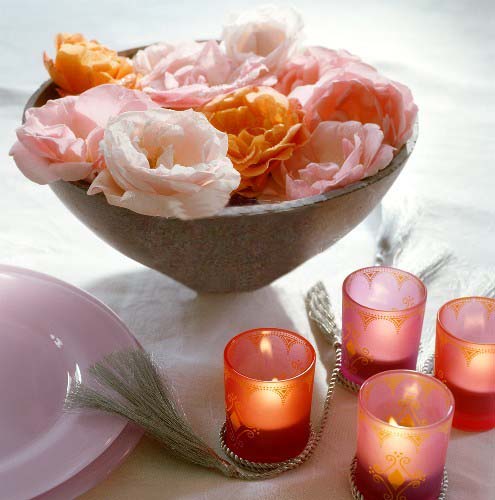 flower painting with pink roses and small candles in glass candle holders