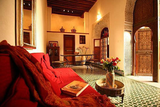 red fabrics and dark wood door for Moroccan style of living