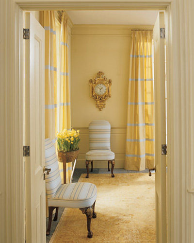 bright yellow color and curtains with gray stripes are bright autumn decorating ideas