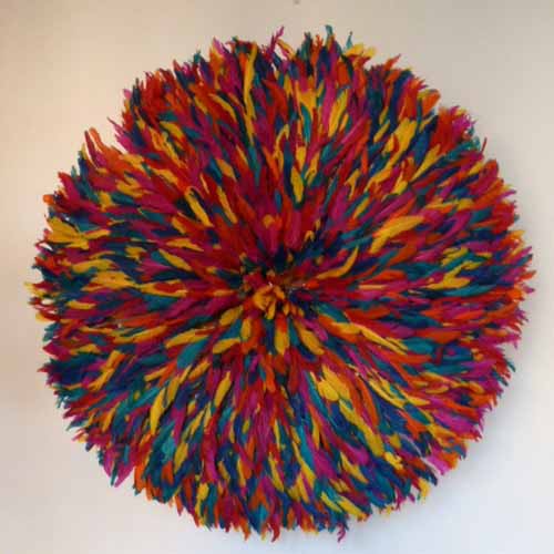juju hat made of colorful bird feathers are modern wall decor ideas