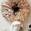 juju hat made of brown and white bird feathers used for modern wall decor