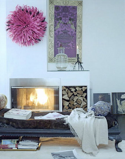 pink juju hat over fireplace is modern wall decor idea