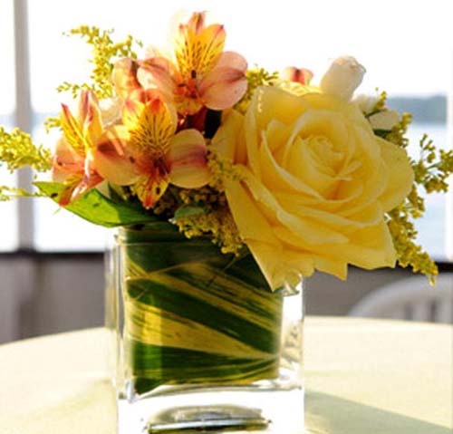 pink and yellow flowers are inviting centerpiece ideas for welcoming table decor