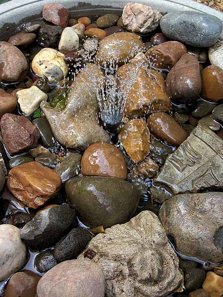 water fountain and beach stones are beautiful backyard ideas