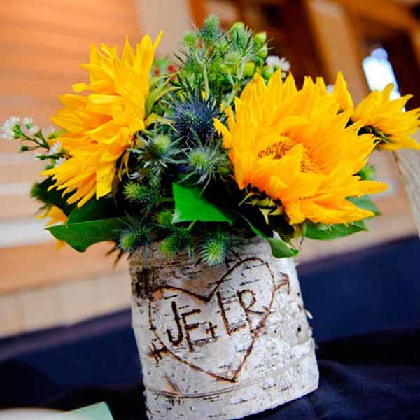 Sunflower and green leaves are beautiful floral centerpiece ideas for table decorations