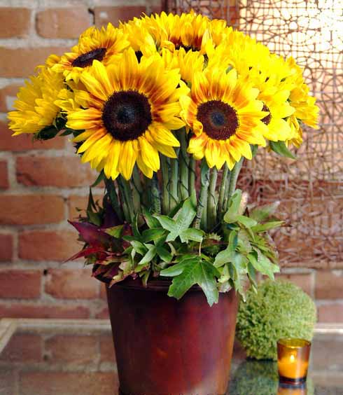 tea lights sunflowers and green leaves centerpiece ideas