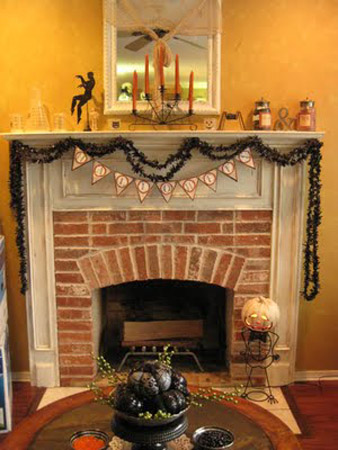 Fireplace decoration with pumpkins and black wreath