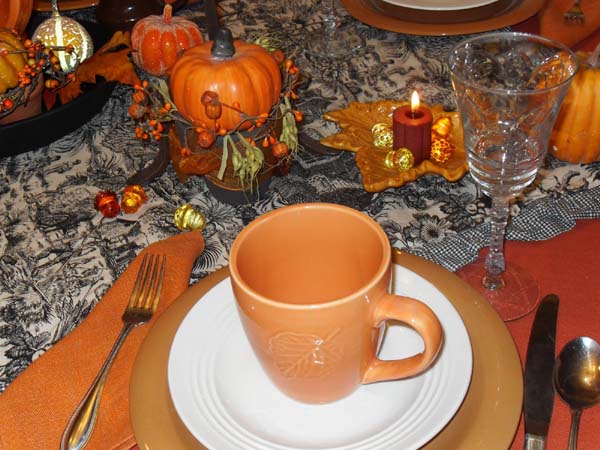 orange crockery cup with leaf pattern for Thanksgiving table decoration