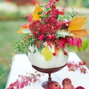 white gourd vase with autumn leaves and apples