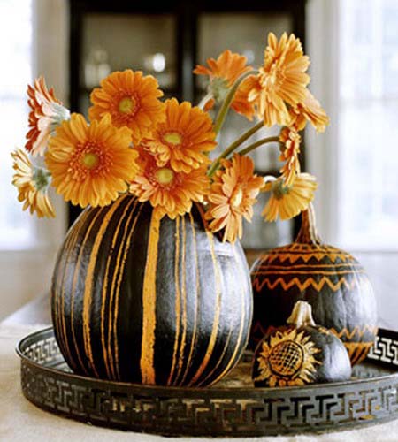 Orange Mums in pumpkin vase with carved orange stripes