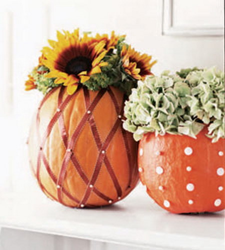 Pumpkin decorated vases with flowers with pins and ribbons