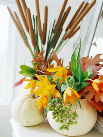 table centerpiece made with white gourd vase and yellow flowers
