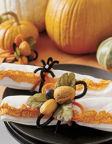 napkin rings made with nuts and green leaves are halloween party decorations