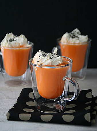 orange mugs on black fabric napkins for halloween decorating