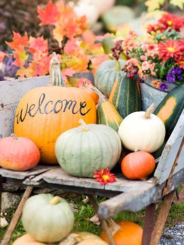 welcoming halloween home and yard decorations made of colorful pumpkins and gourds