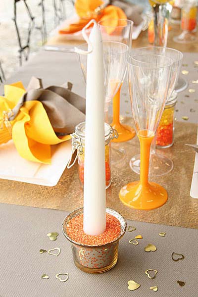 orange glass beads and sand with a candle is one of the CIMple and beautiful table decoration ideas