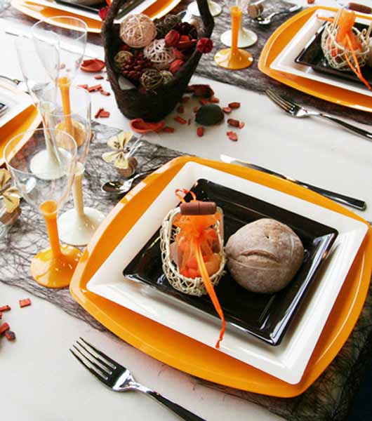 orange plates and whicker decorative balls in a basket is autumn core idea