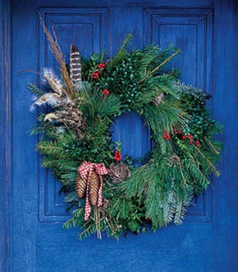 evergreen christmas wreath with pine cones and ribbons