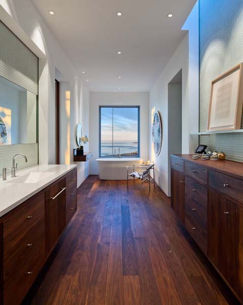 modern bathroom design with wood floors and cabinets