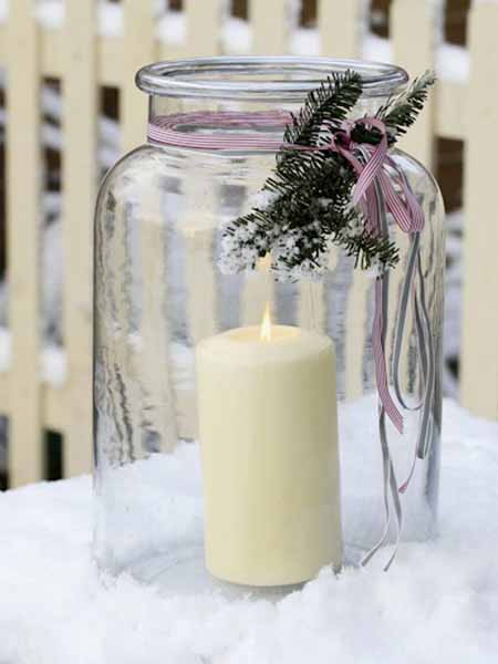 glass and white candle for the winter holiday table decoration