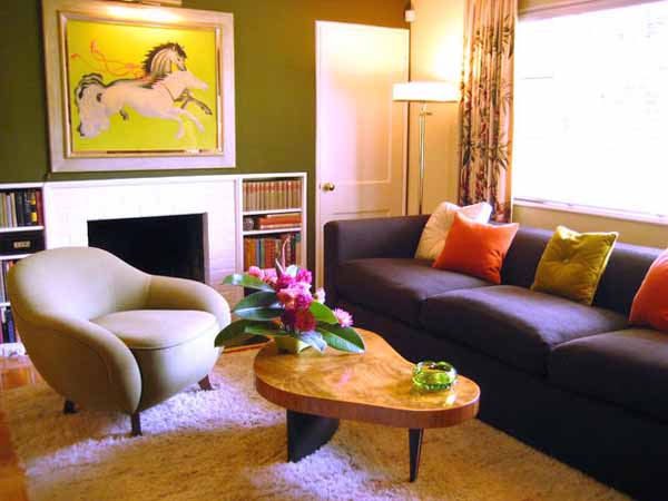 orange cushion on purple-blue sofa