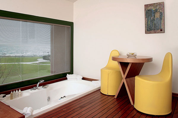 in floor bathtub with wood and leather furniture