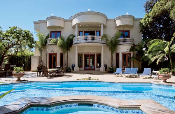 house exterior and an outdoor pool with LED lights