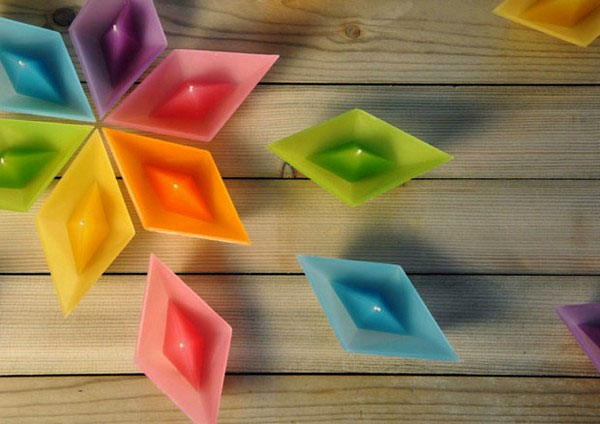 colorful candles in paper boat forms
