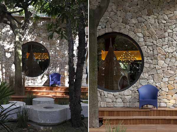 house exterior with blue chair and round window