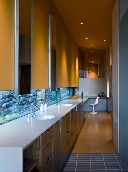 wood kitchen cabinets and large window with rocks veiw