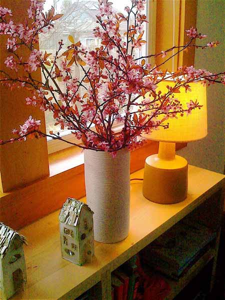 spring branches with pink flowers in ceramic vase