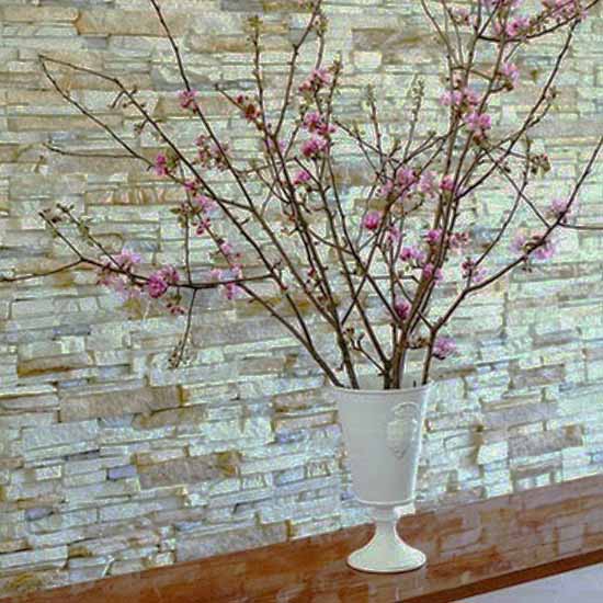 spring branches with pink flowers in white urn