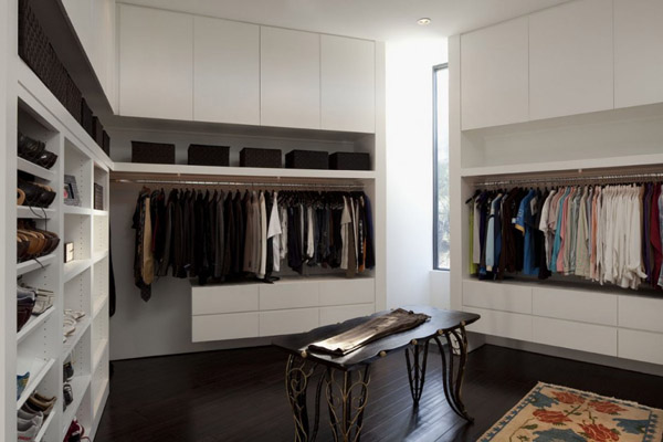 large walk in closet with white cabinets