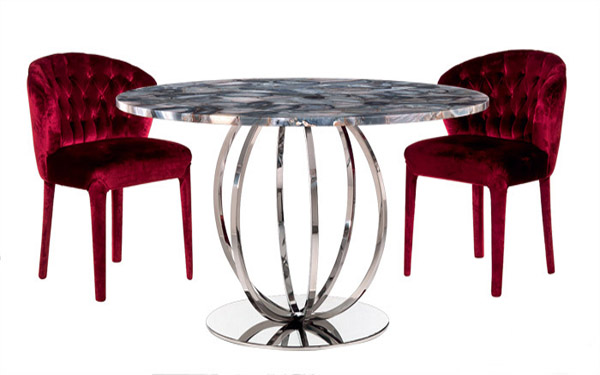 round table and two upholstered chairs in red color