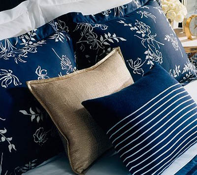 striped and floral pillows in white and blue colors