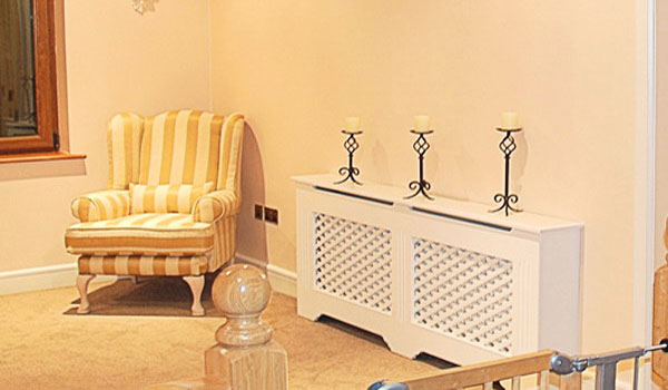 white heater cover with a shelf for wall decorating