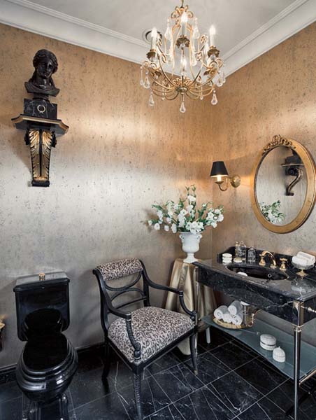 dressing table and chair in bathroom with round wall mirror