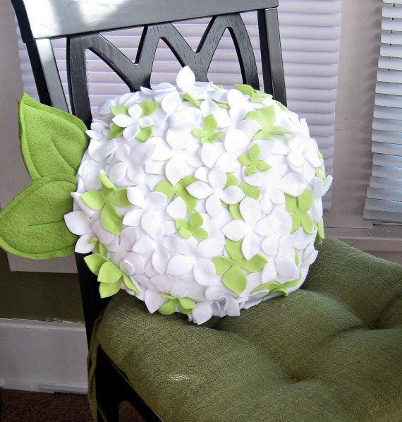 white and green decorative pillows with floral designs