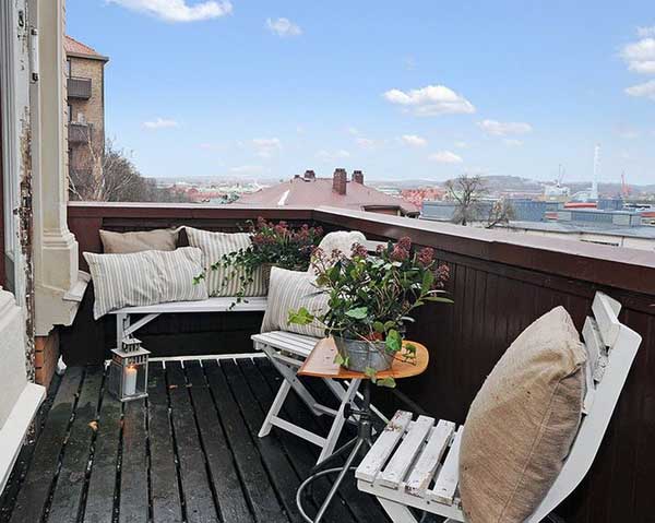 soft pillows and green plants for balcony decorating
