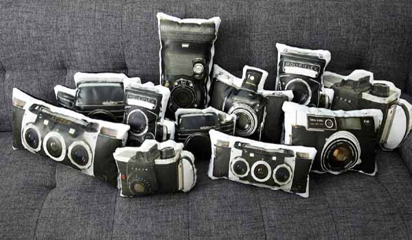 black and white pillows with old camera prints