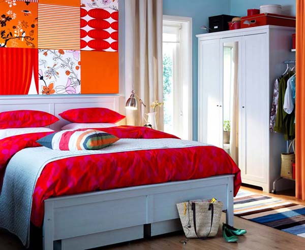 blue wall color and bed linen with red and orange wall decor