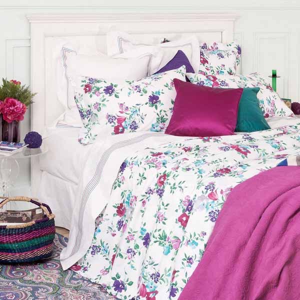 floral bedding set and decorative pillows in solid colors