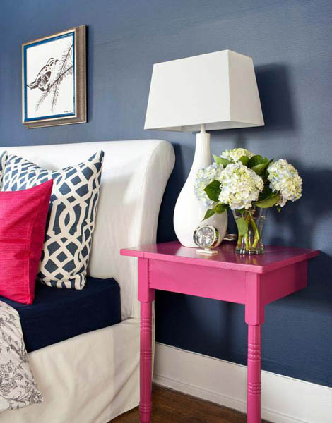Pink nightstand, blue wall paint and white bedroom decor