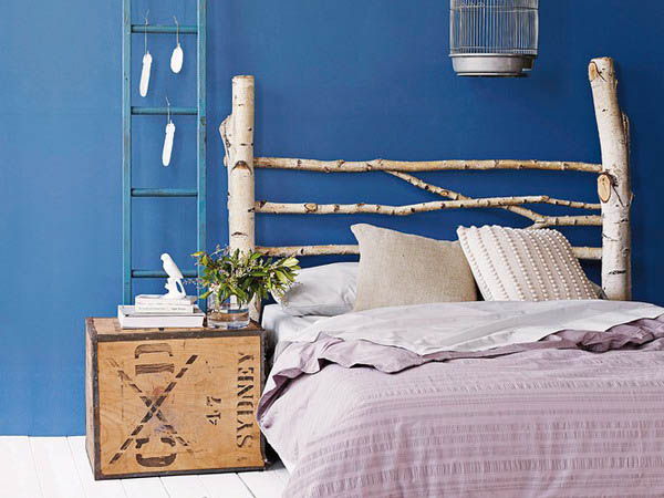 contemporary bedside table, blue wall paint, white bedding