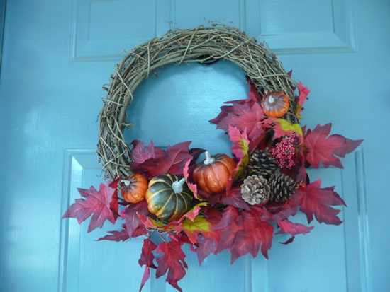 fall vegetables and pine cones with red leaves