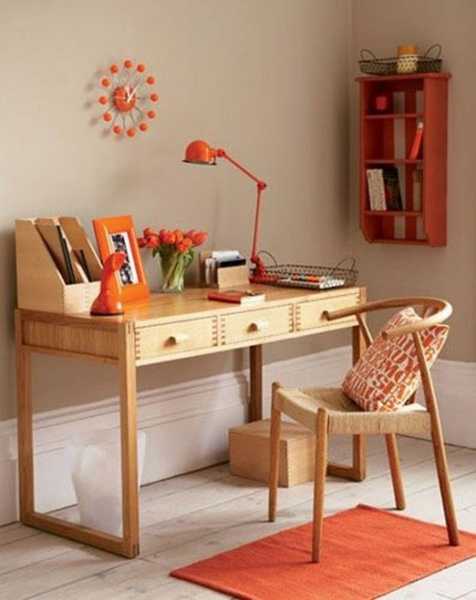 wooden desk and chair with orange lamp