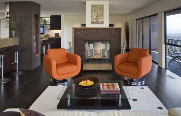 orange chairs next to fireplace